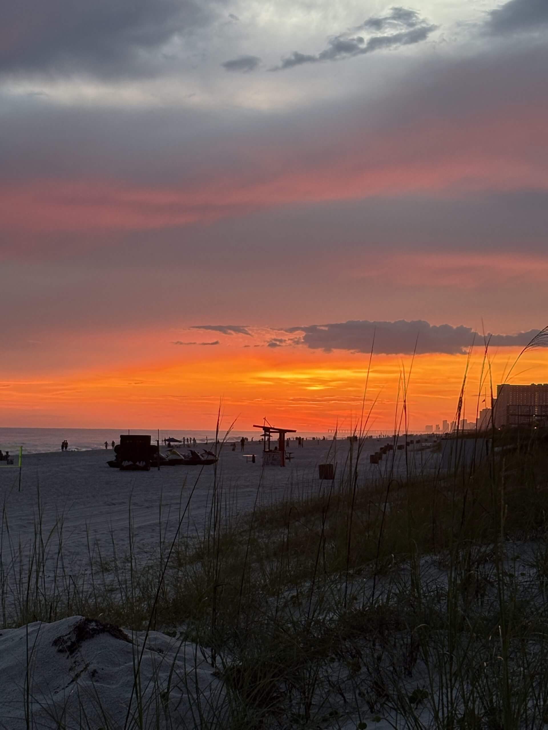 Beach sunset with vibrant orange sky.