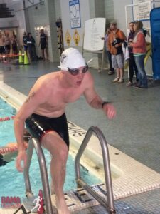 Swimmer exiting pool during triathlon event.
