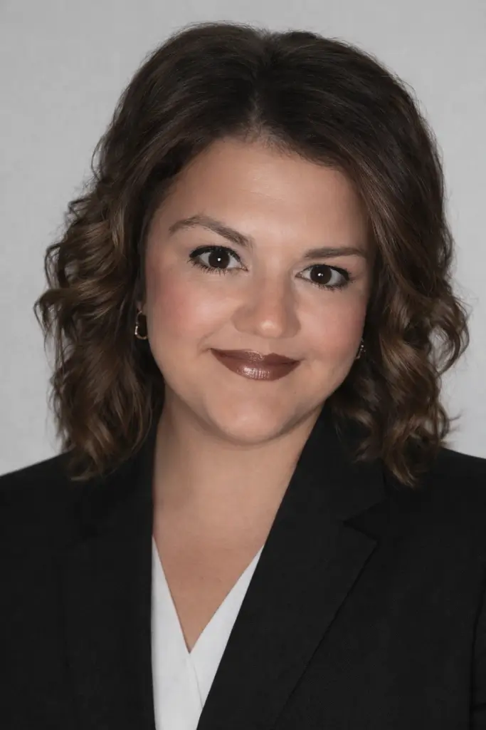 Portrait of a woman with curly hair.